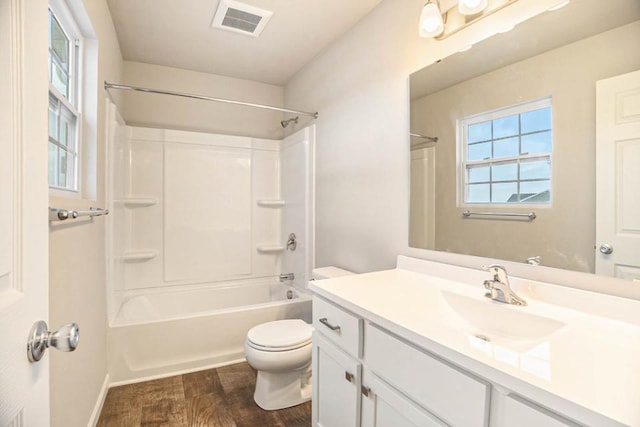 full bathroom with washtub / shower combination, vanity, toilet, and hardwood / wood-style floors