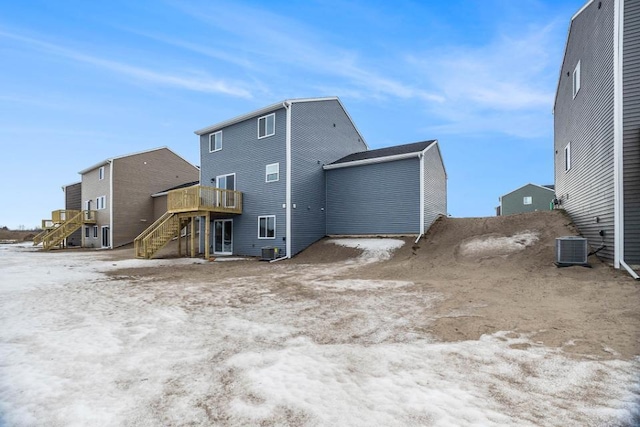 rear view of house with a wooden deck and central AC unit