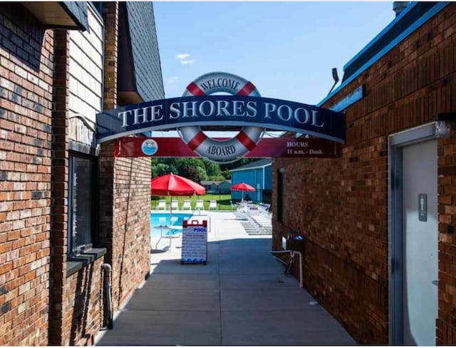 exterior details with a pool and elevator