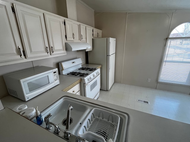 kitchen with sink, white cabinets, and white appliances