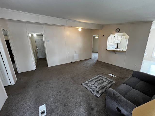 unfurnished living room featuring dark carpet