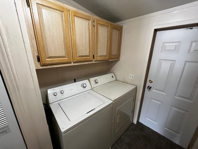 washroom featuring cabinets and washing machine and clothes dryer