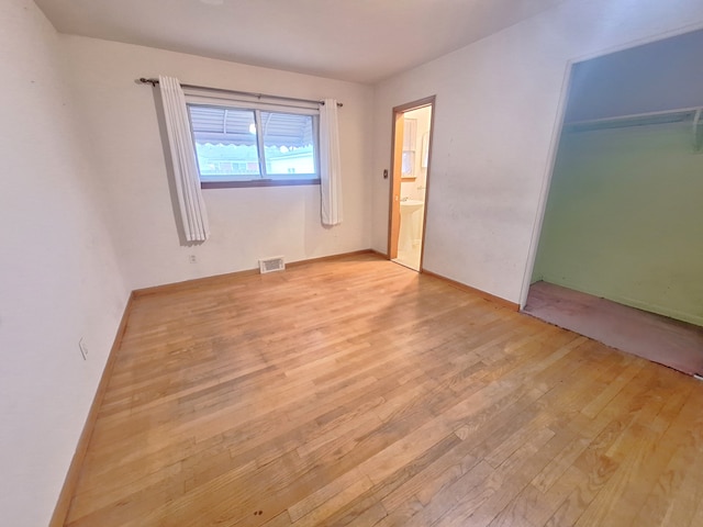 unfurnished room with light wood-type flooring