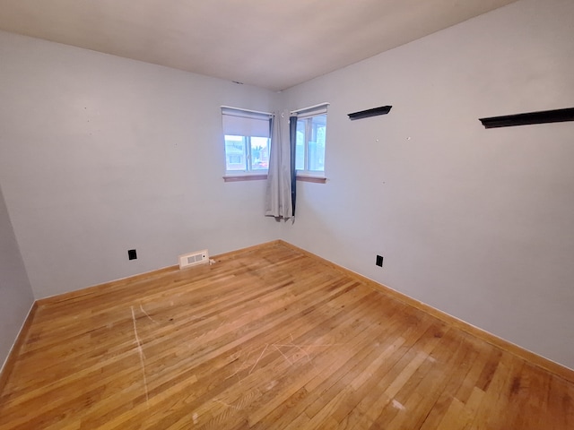 unfurnished room featuring light wood-type flooring