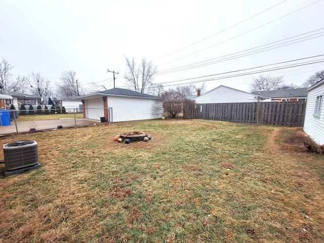 view of yard with a fire pit and central AC