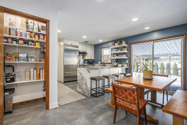 dining area featuring sink and a textured ceiling