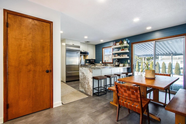 dining space with sink and a textured ceiling