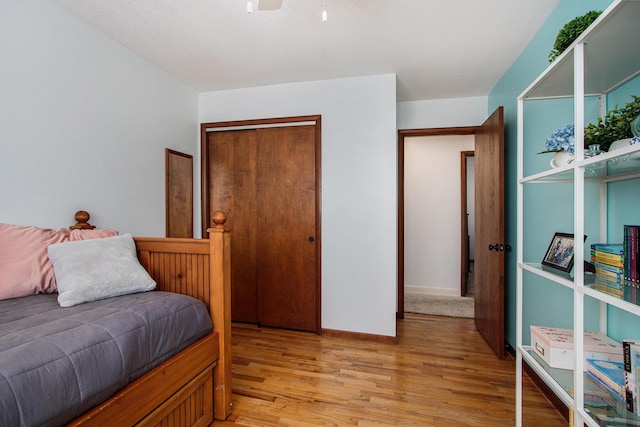 bedroom featuring a closet and light wood-type flooring