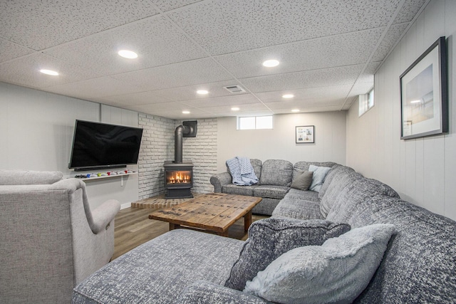 living room featuring a paneled ceiling and wood-type flooring