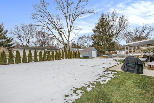 yard layered in snow with a storage unit