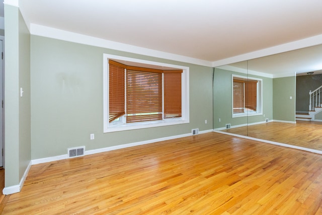 unfurnished room with light hardwood / wood-style floors