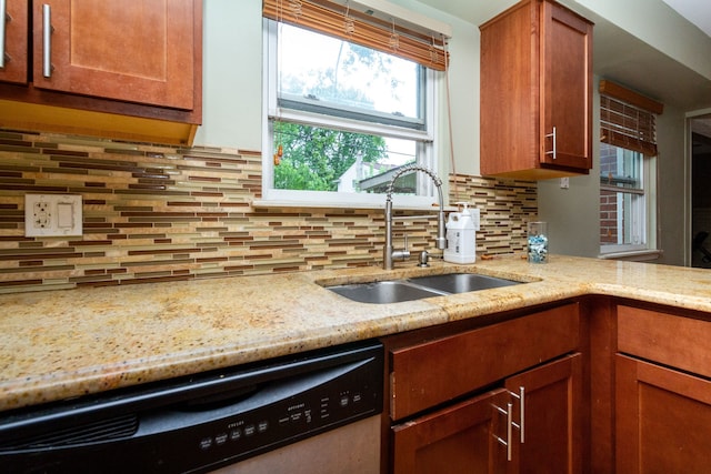 kitchen with tasteful backsplash, stainless steel dishwasher, sink, and light stone counters