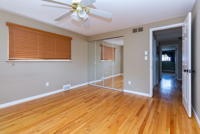 unfurnished bedroom with a closet, ceiling fan, and light hardwood / wood-style flooring