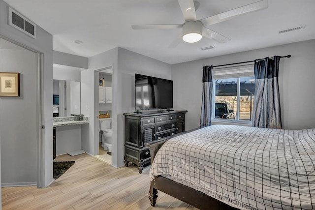 bedroom featuring connected bathroom, ceiling fan, and light wood-type flooring