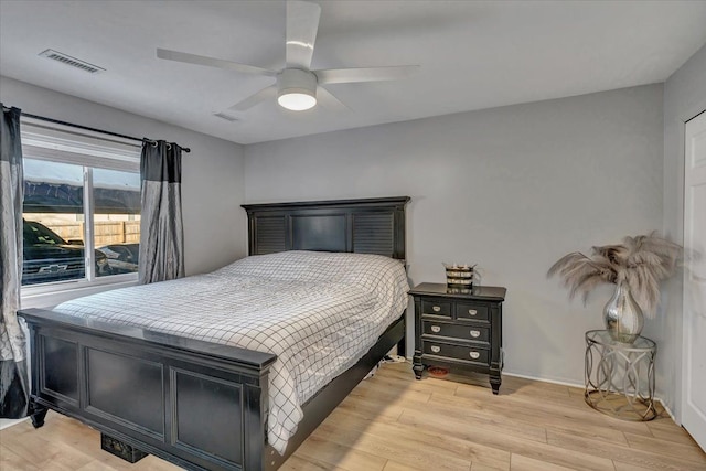 bedroom with ceiling fan and light hardwood / wood-style floors