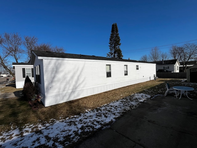 snow covered property with a patio area