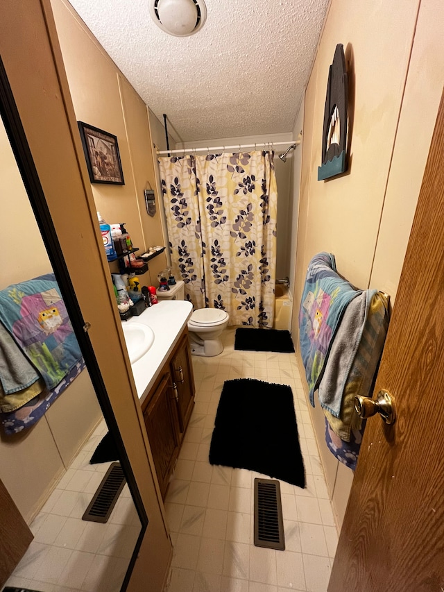 full bathroom with vanity, toilet, a textured ceiling, and shower / bath combo with shower curtain