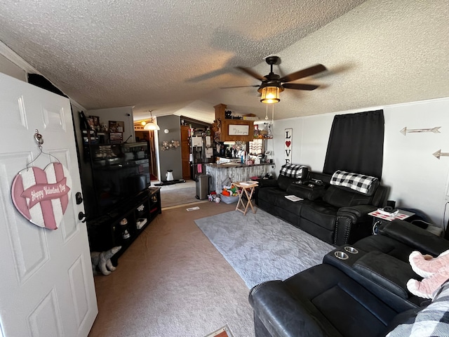 carpeted living room with bar, a textured ceiling, vaulted ceiling, and ceiling fan