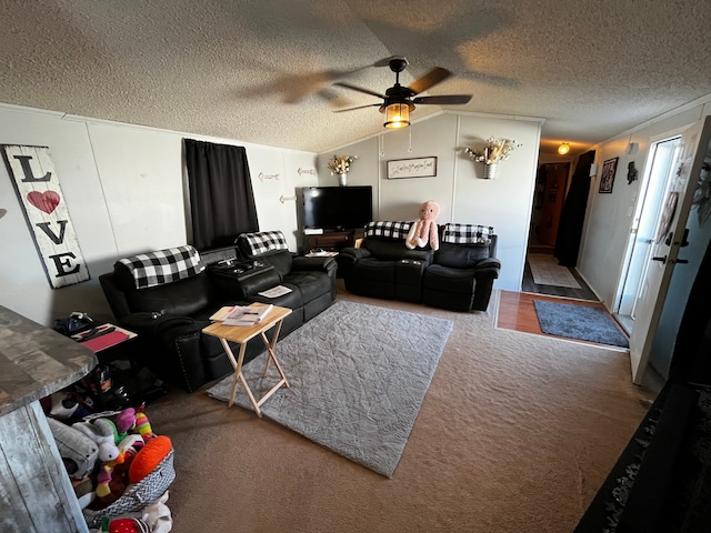 carpeted living room with ceiling fan, lofted ceiling, and a textured ceiling