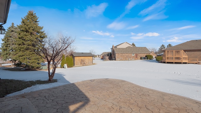 view of yard with a storage shed and a wooden deck