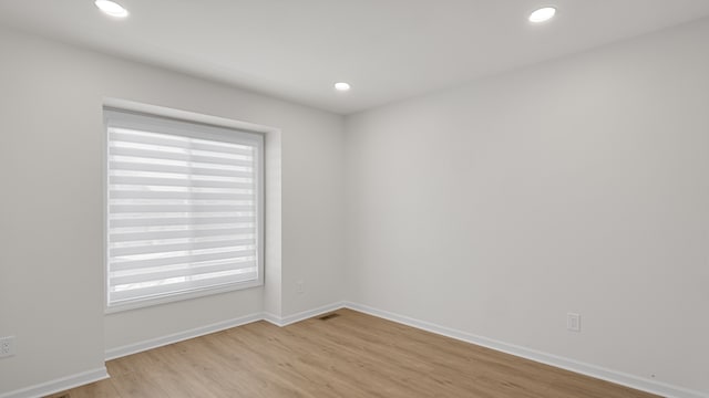 empty room featuring light hardwood / wood-style flooring and a healthy amount of sunlight