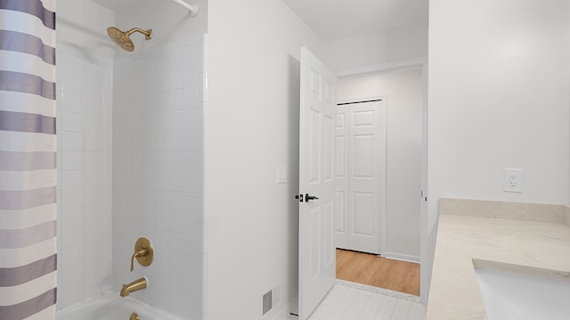 bathroom with vanity and shower / bath combination with curtain