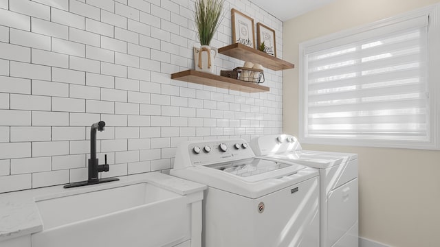 washroom with sink and washer and clothes dryer