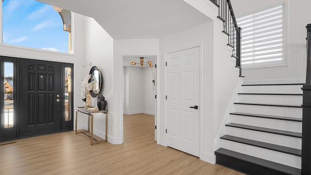 foyer entrance featuring plenty of natural light and light hardwood / wood-style flooring