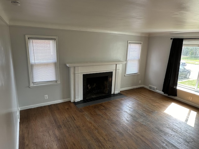 unfurnished living room with dark wood-type flooring and ornamental molding