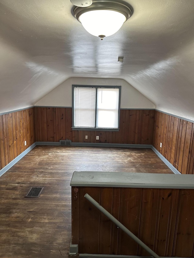 11409 College St, Detroit, MI 48205 - additional living space featuring lofted ceiling, dark hardwood / wood-style floors, a textured ceiling, and wooden walls