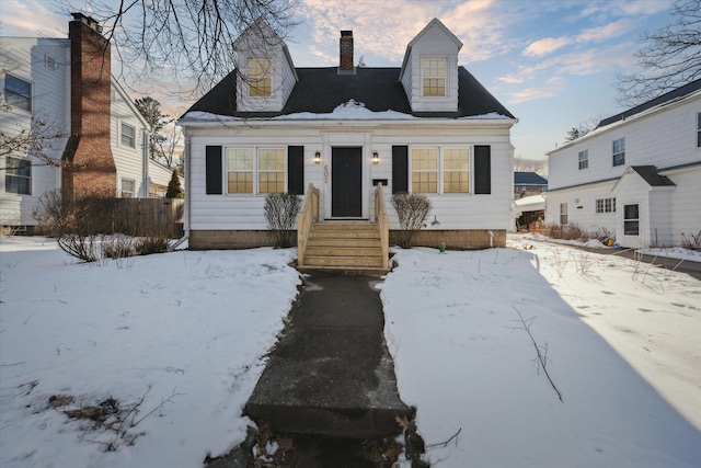 view of front of property with fence and a chimney