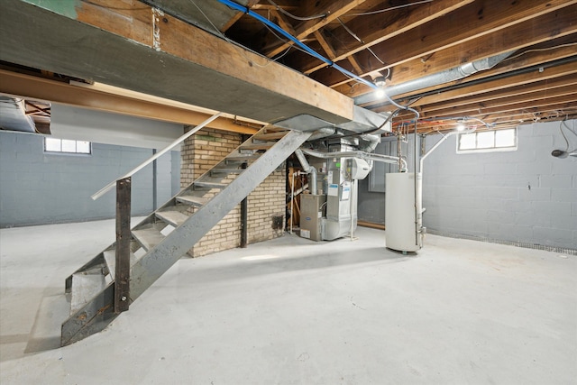 basement featuring heating unit, gas water heater, and stairs