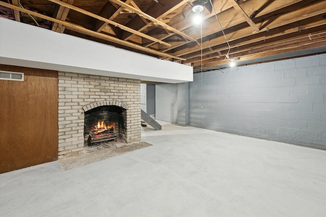 basement featuring a brick fireplace