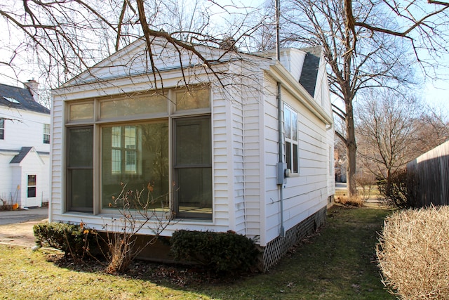 view of property exterior featuring fence and a chimney