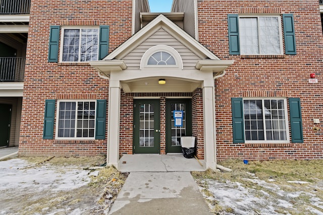 view of snow covered property entrance