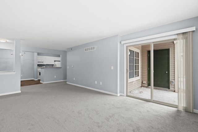 unfurnished living room featuring carpet flooring