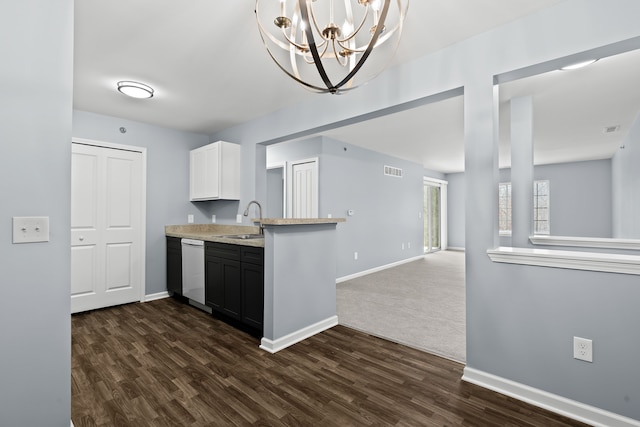 kitchen with white cabinetry, dark hardwood / wood-style floors, dishwasher, and sink