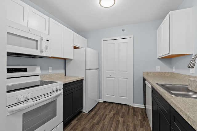 kitchen with white cabinetry, dark hardwood / wood-style floors, sink, and white appliances