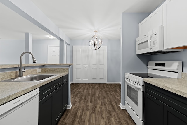 kitchen featuring sink, white appliances, white cabinetry, dark hardwood / wood-style floors, and decorative light fixtures