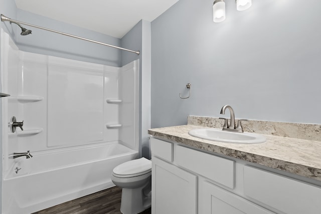 full bathroom with vanity, hardwood / wood-style flooring, toilet, and washtub / shower combination