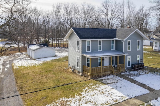 view of front of house featuring a porch, a yard, and a storage shed