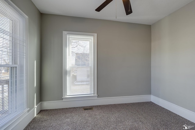 carpeted spare room with ceiling fan