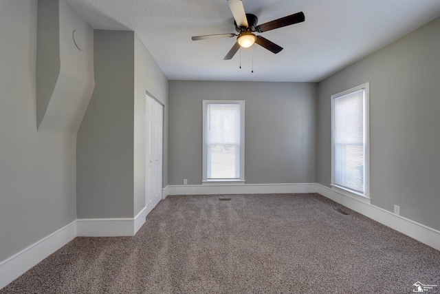 unfurnished room with ceiling fan and carpet floors