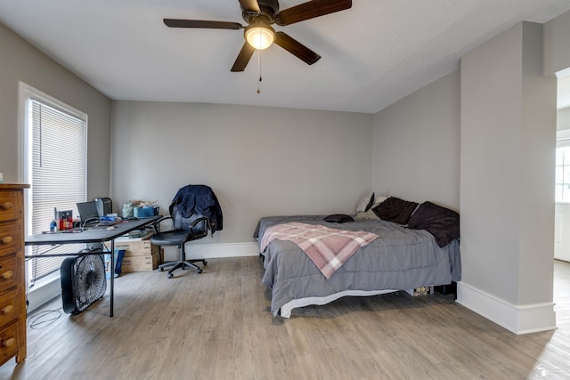 bedroom with ceiling fan and light wood-type flooring