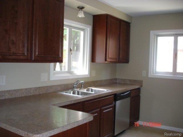 kitchen with dishwasher, sink, and light tile patterned floors