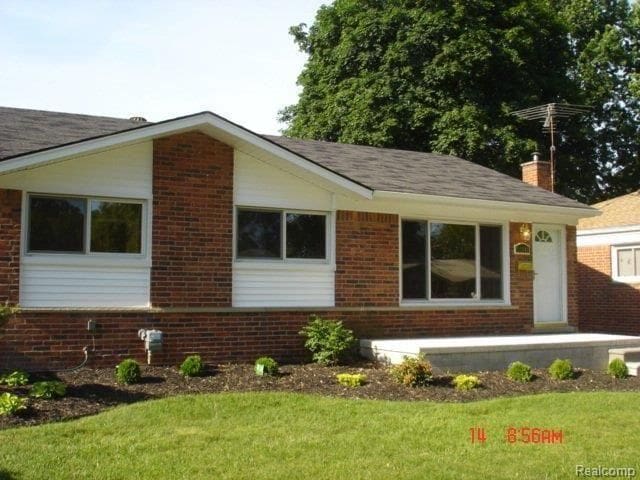 view of side of home featuring a lawn