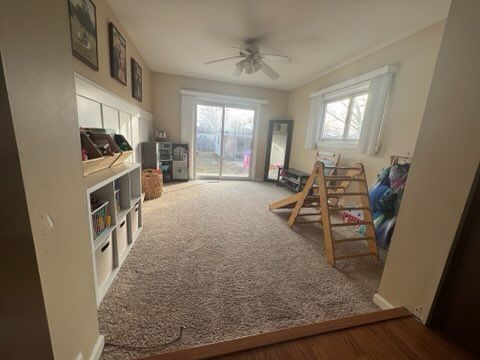 playroom with ceiling fan and carpet flooring