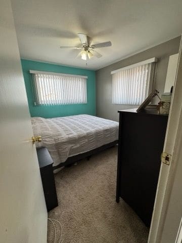 bedroom with light colored carpet and ceiling fan