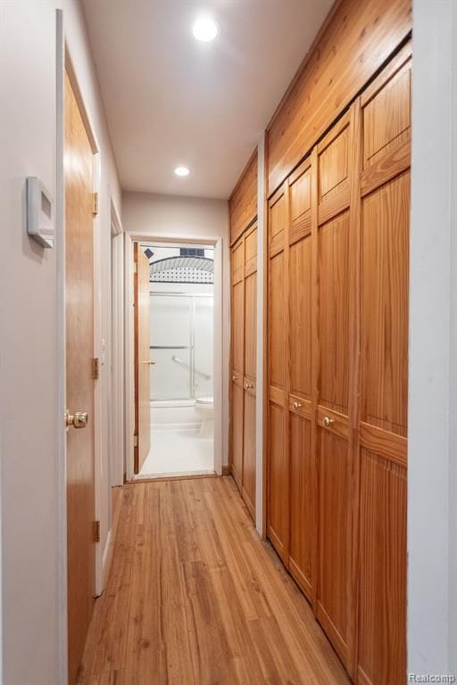 corridor with light hardwood / wood-style flooring