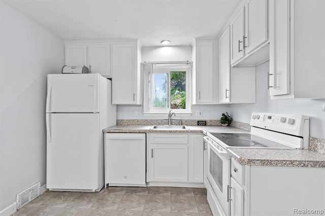 kitchen featuring white cabinetry, white appliances, and sink